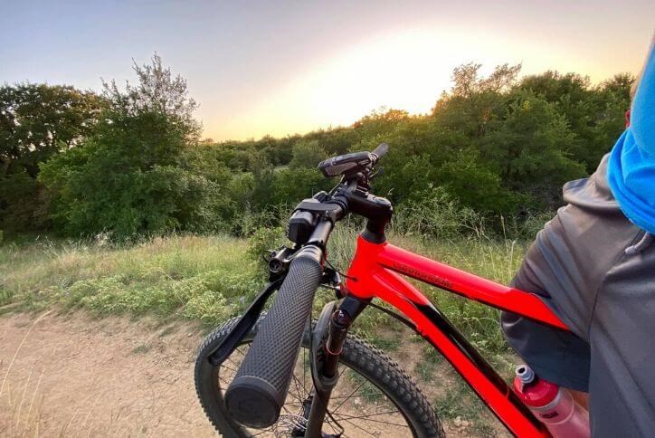 Close up of a red bike on Canyon Falls trails at sunset